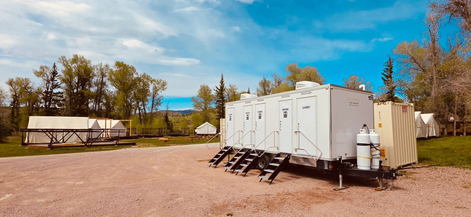 Combination shower restroom and laundry trailer